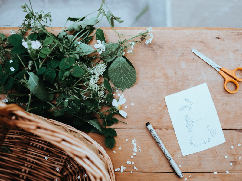 A floral arrangement on a wooden bench